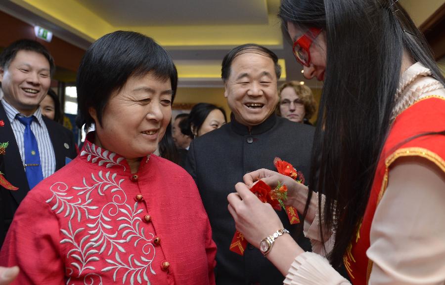 Chinese writer Mo Yan (2nd R), the 2012 Nobel Prize winner for literature, and his wife (2nd L) attend a reception by Chinese entrepreneurs in Stockholm, capital of Sweden, Dec. 8, 2012. (Xinhua/Wu Wei) 