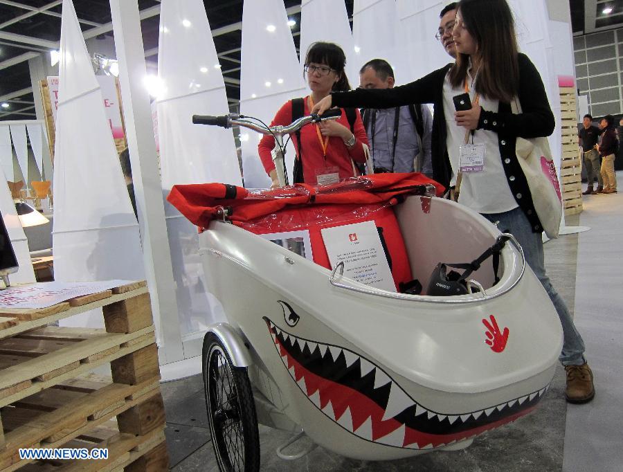 Visitors look at an exotic bicycle design on display at the 8th Inno Design Tech Expo in south China's Hong Kong, Dec. 7, 2012. The three-day exposition kicked off Thursday at Hong Kong Convention and Exhibition Center, with more than 350 exhibitors from 11 countries and regions. (Xinhua/Zhao Yusi) 