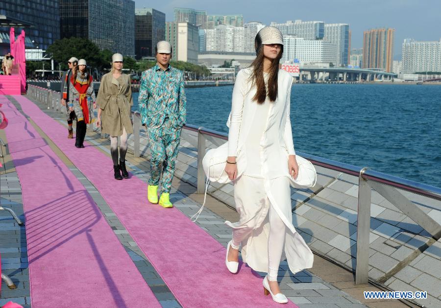 Models are pictured during a catwalk show "The World's Greatest Catwalk" in Victoria Harbour waterfront of Tsim Sha Tsui promenade, south China's Hong Kong, Dec. 9, 2012. The World's Greatest Catwalk 2012 broke the Guinness World Record of the world's longest catwalk on Sunday by having more than 340 models walking on a three kilometers long catwalk. (Xinhua/Zhao Yusi) 