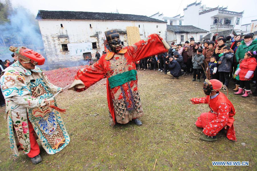 File photo taken on Jan. 24, 2012 shows Nuo dance artists giving performance in Changjing Village of Wuyuan County, east China's Jiangxi Province. (Xinhua/Zhang Weiguo)