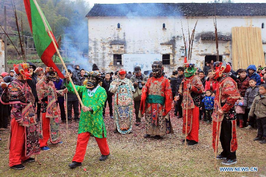 File photo taken on Jan. 24, 2012 shows Nuo dance artists giving performance in Changjing Village of Wuyuan County, east China's Jiangxi Province. (Xinhua/Zhang Weiguo)