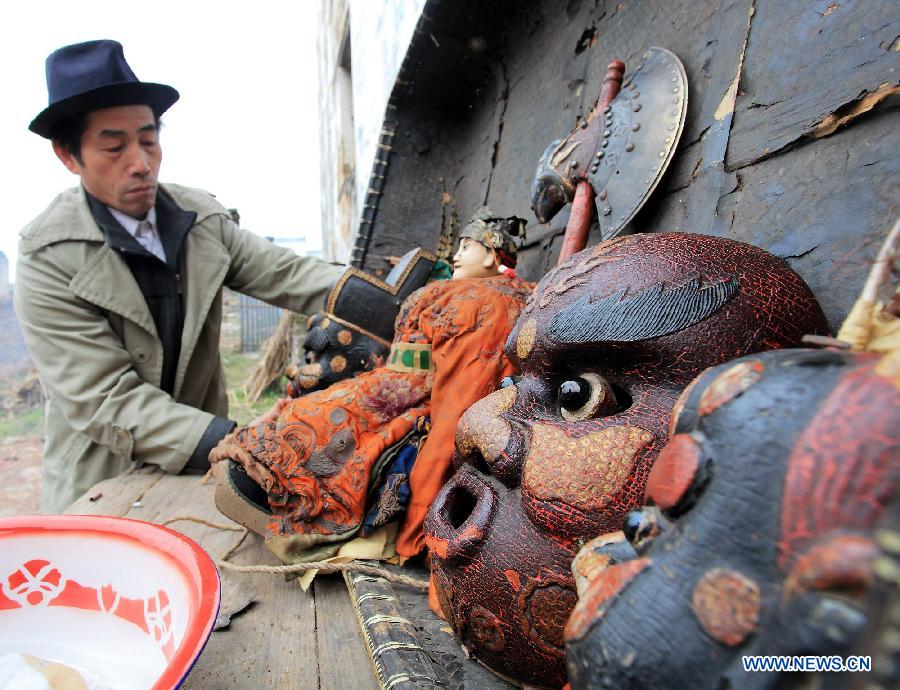 File photo taken on Jan. 24, 2012 shows a pre-performance ritual to worship the Nuo deity is held in Changjing Village of Wuyuan County, east China's Jiangxi Province. (Xinhua/Zhang Weiguo)