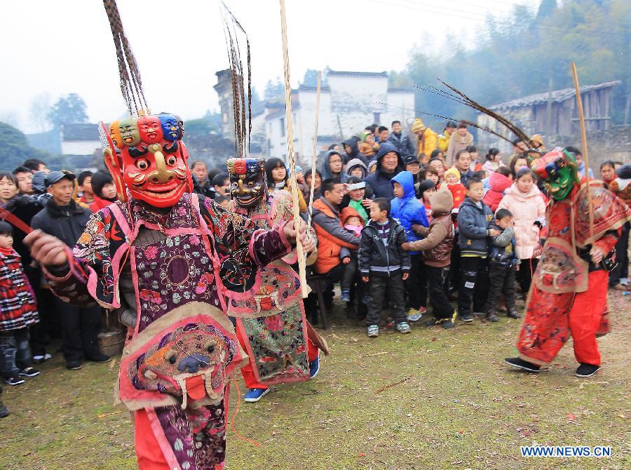 File photo taken on Jan. 24, 2012 shows Nuo dance artists give performance in Changjing Village of Wuyuan County, east China's Jiangxi Province. (Xinhua/Zhang Weiguo)