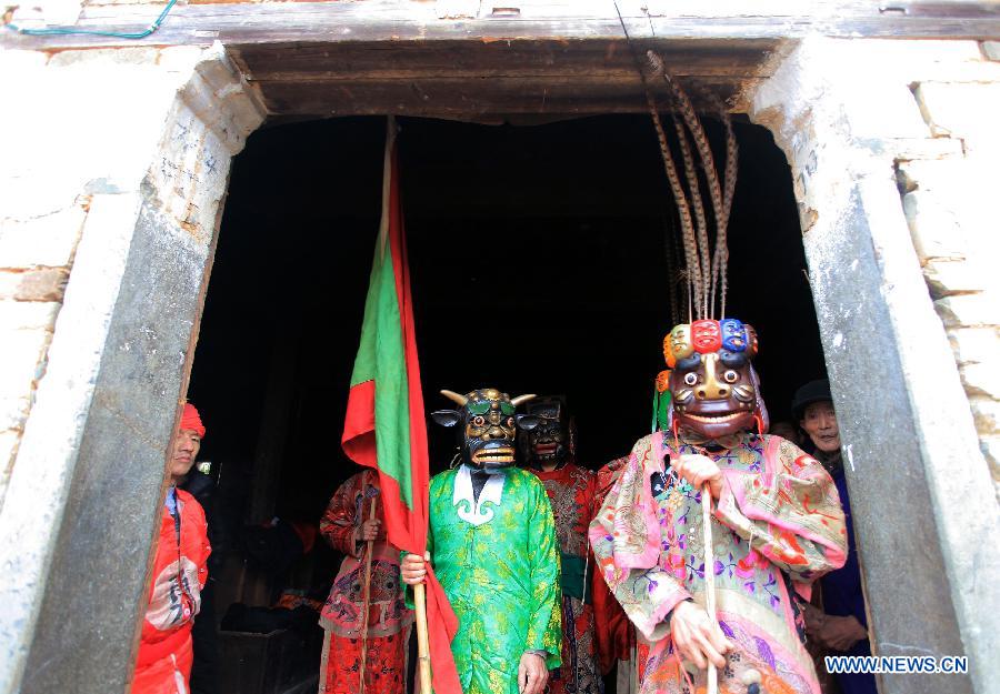 File photo taken on Jan. 24, 2012 shows Nuo dance artists preparing for performance in Changjing Village of Wuyuan County, east China's Jiangxi Province. (Xinhua/Zhang Weiguo)