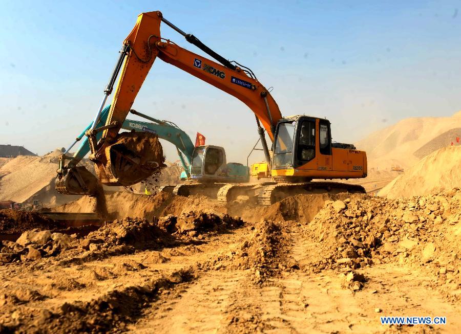 Construction vehicles work at a hilly region in Lanzhou, capital of northwest China's Gansu Province, Dec. 10, 2012. A project of land development has been under construction here since this October as the city planned to remove some of its barren hills to provide land of 25 square kilometers in half a year for city development. (Xinhua/Nie Jianjiang) 