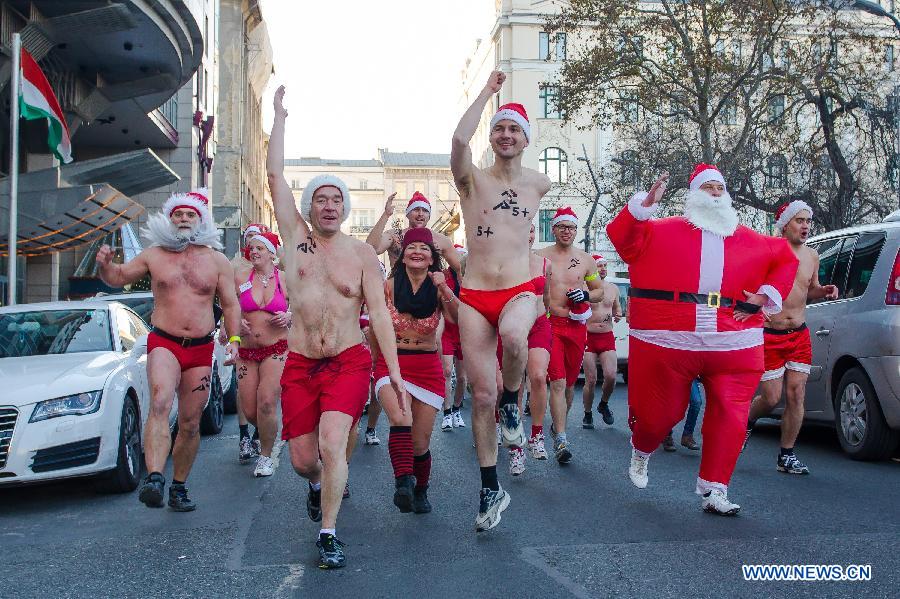 People take part in a half naked "Santa run" in Budapest, Hungary, Dec. 9, 2012. (Xinhua/Attila Volgyi) 