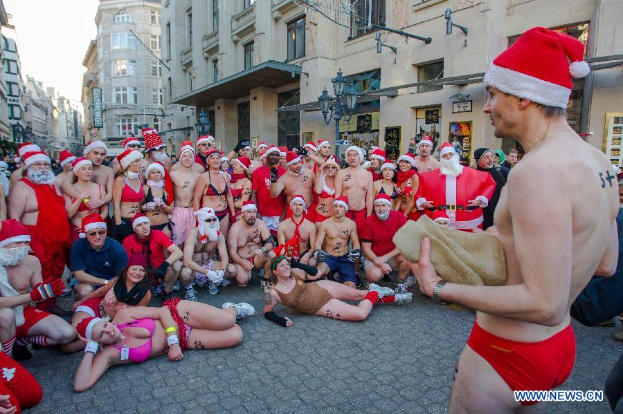 People take part in a half naked "Santa run" in Budapest, Hungary, Dec. 9, 2012. (Xinhua/Attila Volgyi) 