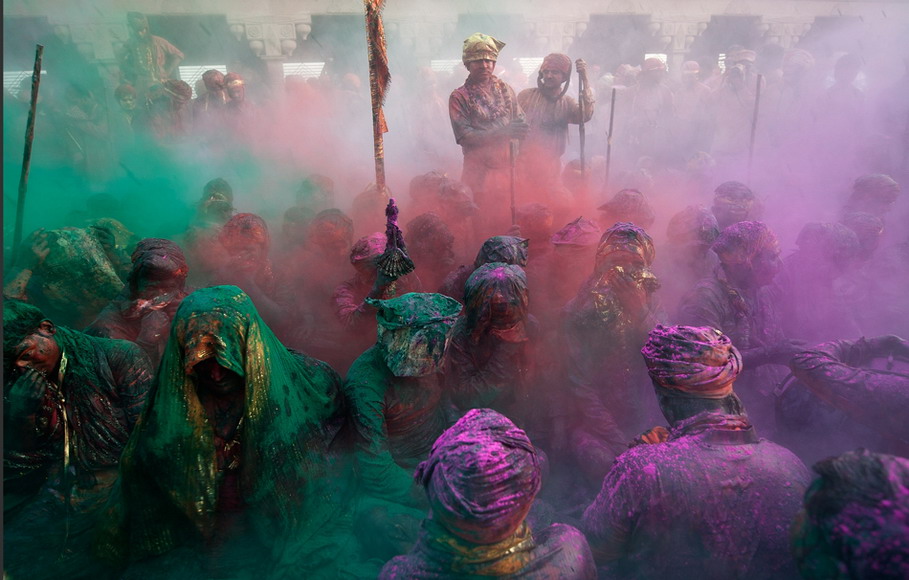 People smear colors on body during Holi Festival in India, March 3, 2012. Holi Festival is a religious spring festival celebrated by Hindus, as a festival of colors.