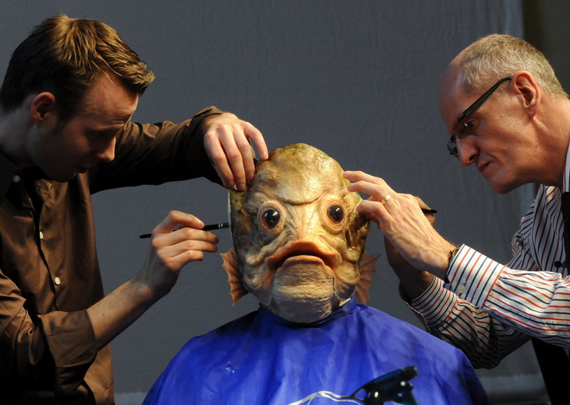 Two artists dress a tenor singer up as a carp at the press conference for “Make-up artist design exhibition of year 2012” in Dusseldorf, Germany on March 1, 2012. (Photo/AFP)