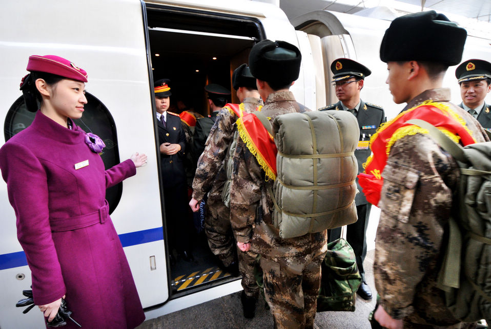 New recruits for the People's Liberation Army wait for the train to leave at a train station. The People's Liberation Army has launched its annual winter conscription this year. (Xinhua)