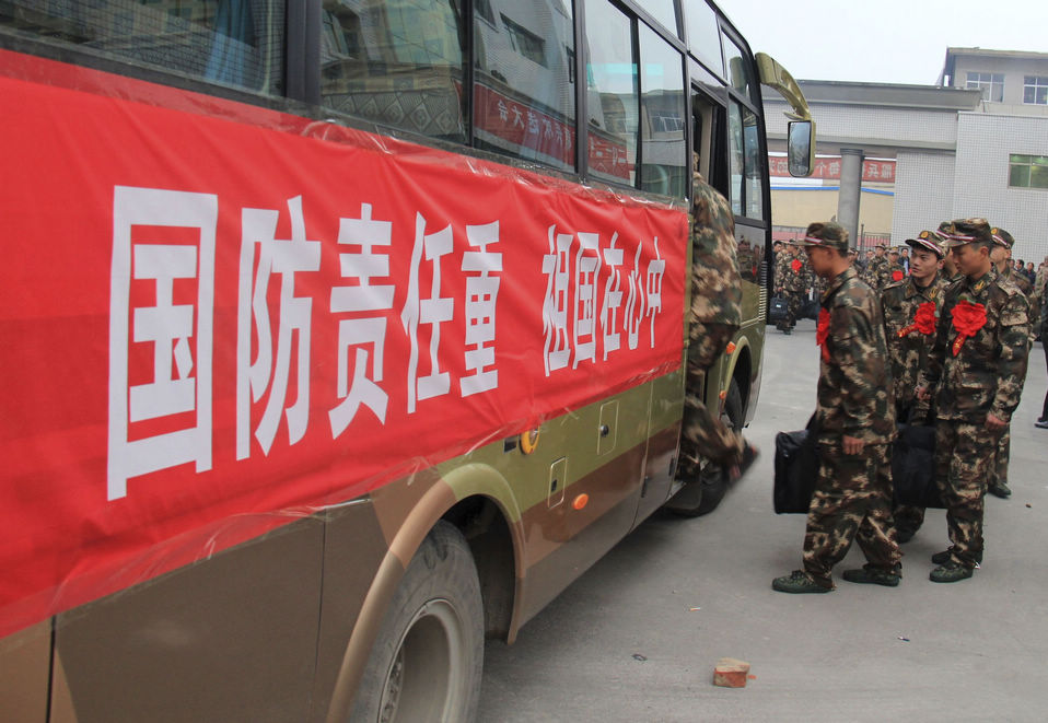 New recruits for the People's Liberation Army wait for the train to leave at a train station. The People's Liberation Army has launched its annual winter conscription this year. (Xinhua)