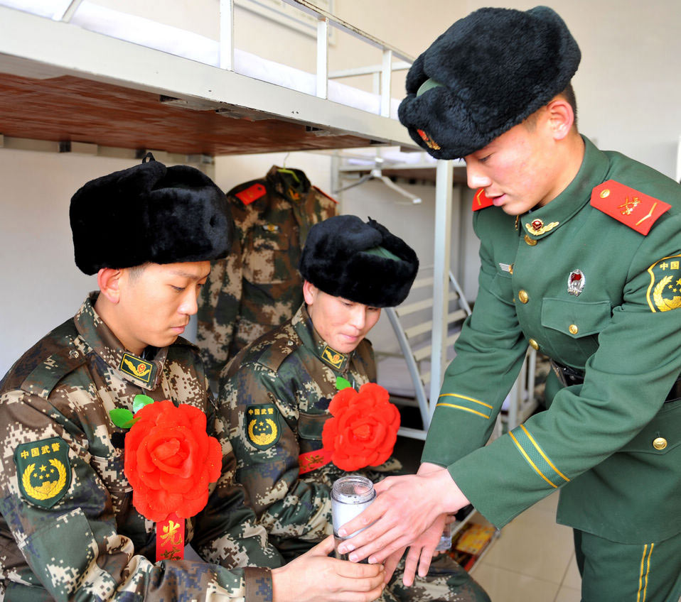 New recruits for the People's Liberation Army wait for the train to leave at a train station. The People's Liberation Army has launched its annual winter conscription this year. (Xinhua)