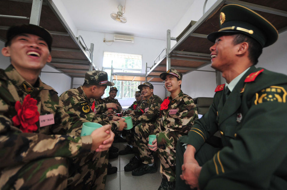 New recruits for the People's Liberation Army wait for the train to leave at a train station. The People's Liberation Army has launched its annual winter conscription this year. (Xinhua)