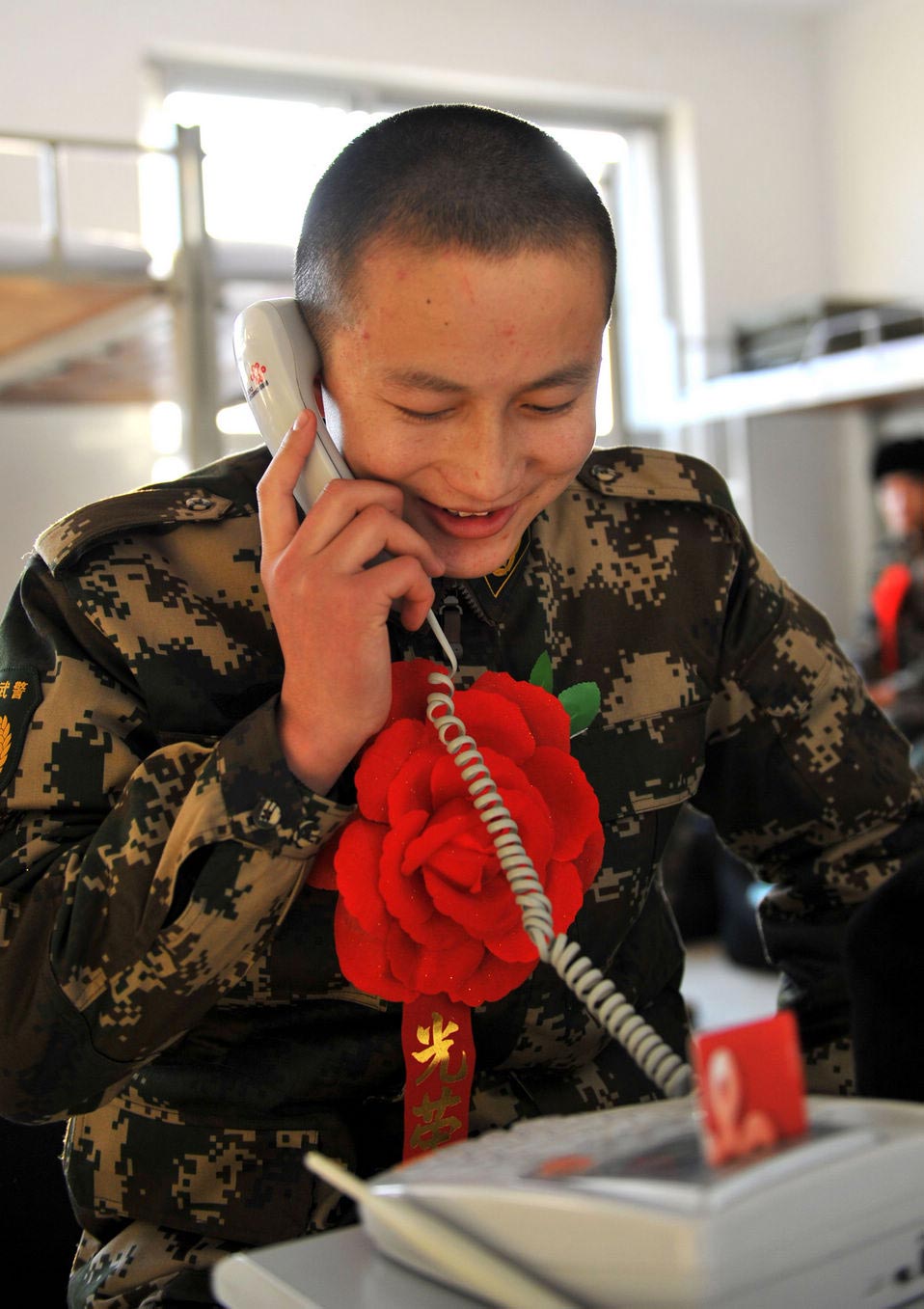 New recruits for the People's Liberation Army wait for the train to leave at a train station. The People's Liberation Army has launched its annual winter conscription this year. (Xinhua)