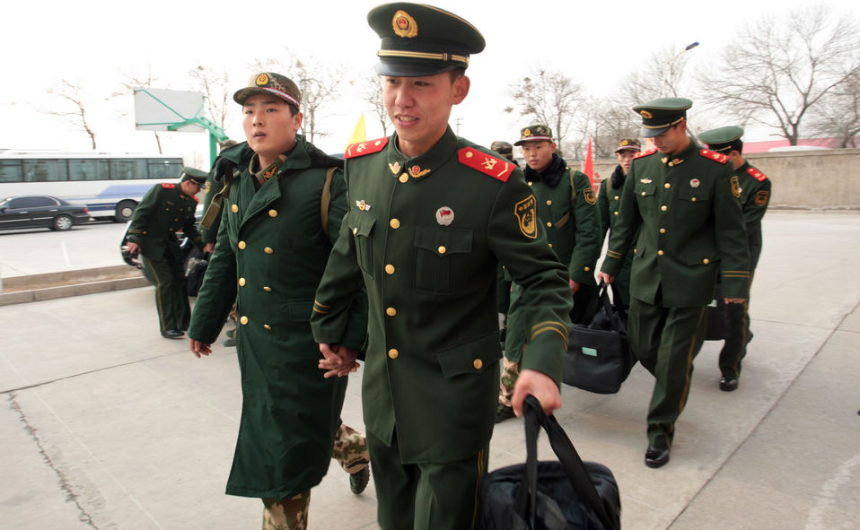 New recruits for the People's Liberation Army wait for the train to leave at a train station. The People's Liberation Army has launched its annual winter conscription this year. (Xinhua)