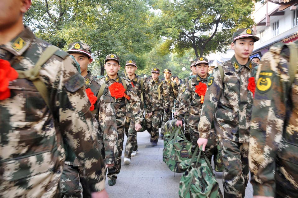 New recruits for the People's Liberation Army wait for the train to leave at a train station. The People's Liberation Army has launched its annual winter conscription this year. (Xinhua/Zhou Xiaoming)