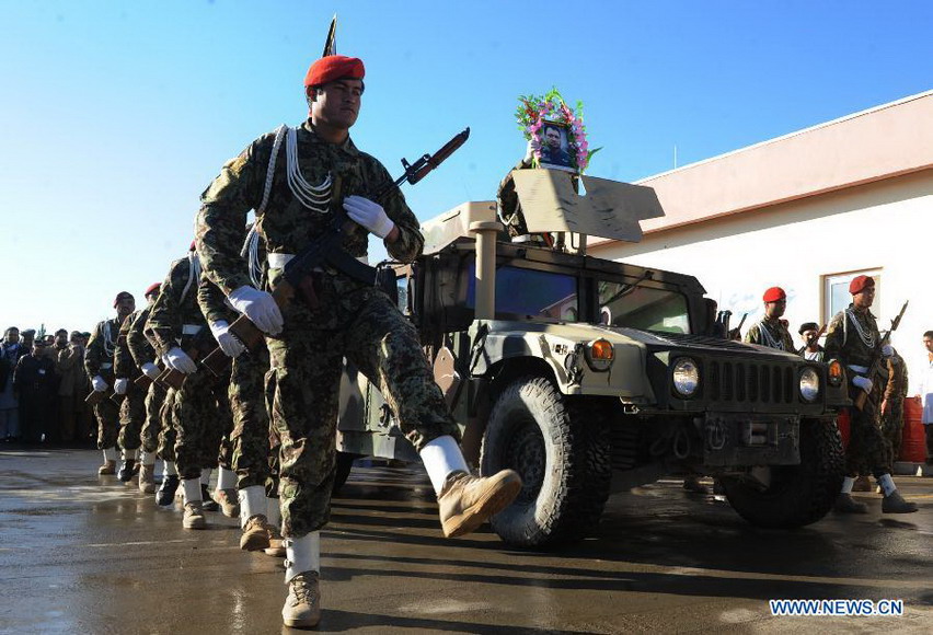 Afghan soldiers march during the funeral of Mohammad Musa Rasouli, the provincial police chief of Afghanistan's southwestern province of Nimroz, in Herat province, west of Afghanistan, on Dec. 11, 2012. (Xinhua/Sardar)  