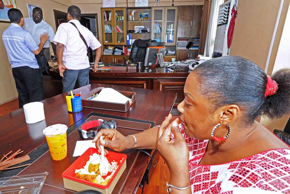 Senegalese merchant Mamadou Sall (2nd L Back) talks business with his clients as his wife Fatima has a lunch in Sall-Industrial Co., Ltd. in Yiwu, east China's Zhejiang Province, July 15, 2012. (Xinhua/Tan Jin) 