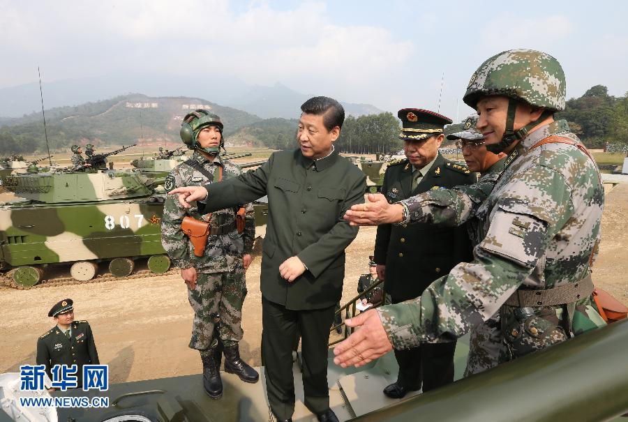 General Secretary of the Communist Party of China (CPC) Central Committee Xi Jinping (C), who is also the chairman of the CPC Central Military Commission, examines an armored vehicle at the Guangzhou military theater of operations of the People's Liberation Army (PLA), Dec. 10, 2012. (Xinhua/Wang Jianmin)
