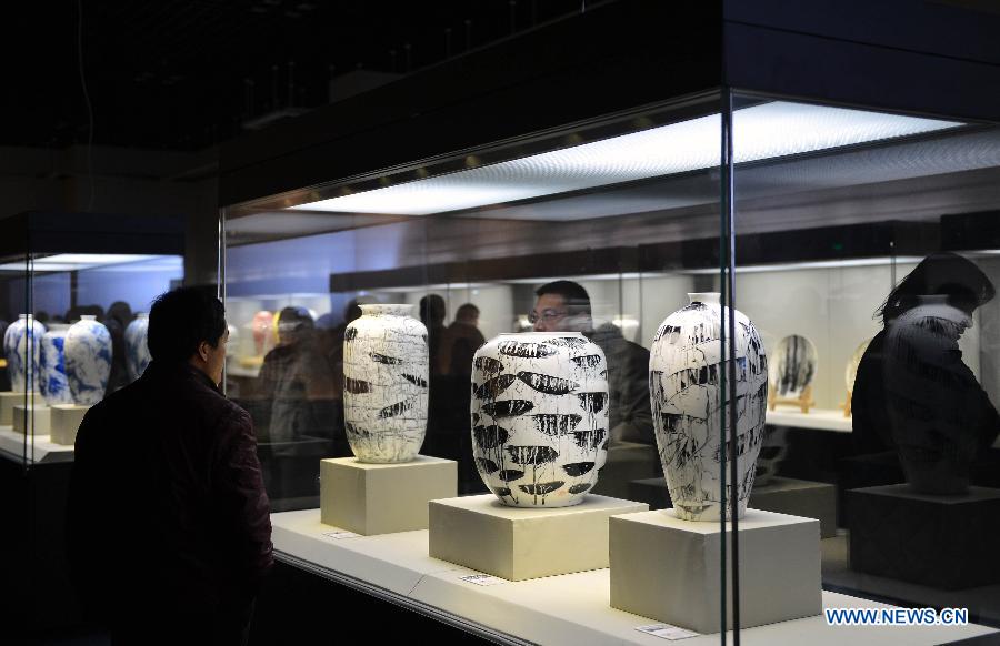 Visitors view porcelain artworks created by Chinese artist Pan Lusheng at Pan's solo art exhibition in Shandong Museum in Jinan, capital of east China's Shandong Province, Dec. 12, 2012. Nearly 100 pieces of porcelain artworks by Pan were displayed at the exhibition which kicked off on Wednesday. (Xinhua/Zhu Zheng)