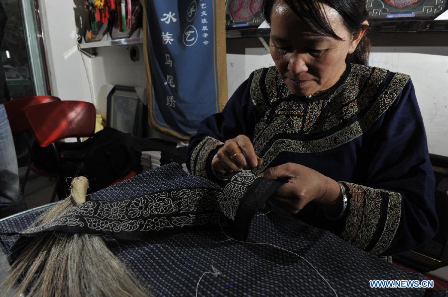 Wei Taohua, a horse-tail embroidery craftswoman of Shui ethnic group, embroiders in Sandu, southwest China's Guizhou Province, Dec. 12, 2012. (Xinhua/Ou Dongqu)