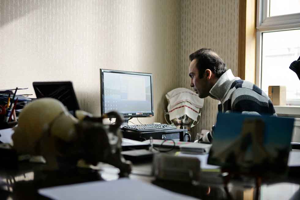 Peyam, president of Smile English School, works in his office in Yinchuan, capital of northwest China's Ningxia Hui Autonomous Region, March 15, 2012. (Xinhua/Zheng Huansong)