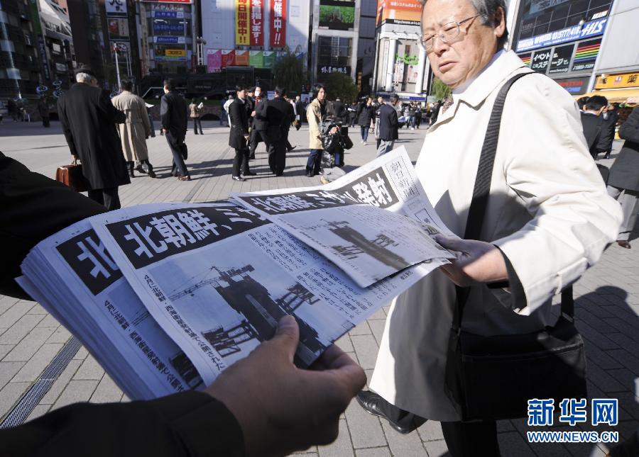 A staff member of the Asahi Shimbun delivers the extra of the newspaper with reports about the rocket launch by the Democratic People's Republic of Korea (DPRK), in Tokyo, Japan, Dec. 12, 2012. The DPRK on Wednesday successfully launched and orbited a Kwangmyongsong-3 satellite, the official news agency KCNA reported. (Xinhua/Kenichiro Seki)