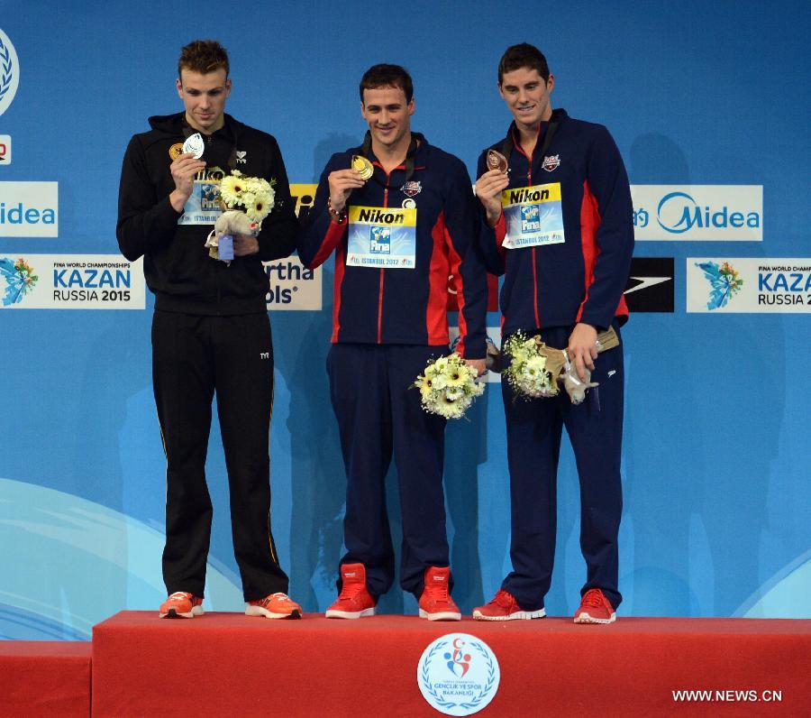 Ryan Lochte (C) of the United States, Paul Biedermann (L) of Germany and Conor Dwyer of the Uniteds States pose for photograph during the awarding ceremony of the men's 200m freestyle at the 11th FINA World Swimming Championships in Istanbul, Turkey, on Dec. 12, 2012. (Xinhua/Ma Yan)