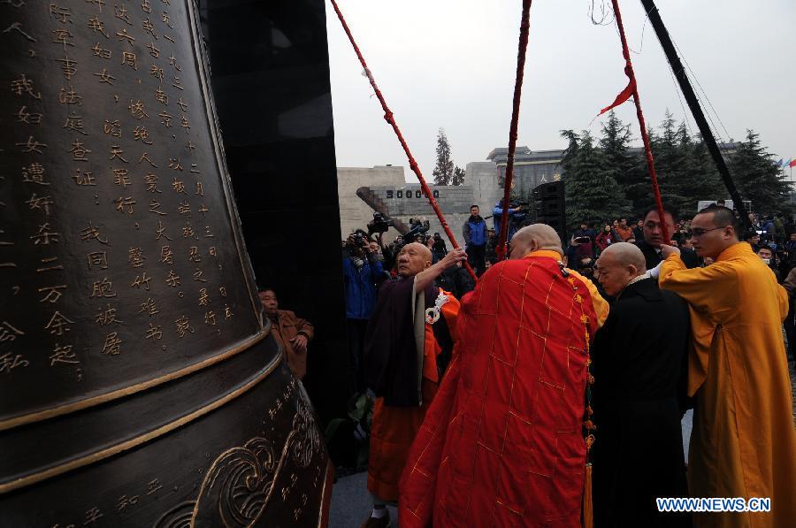 Representatives of Chinese and Japanese religious circle toll the bell of peace during a memorial ceremony at the Memorial Hall of the Victims in Nanjing Massacre by Japanese Invaders in Nanjing, capital of east China's Jiangsu Province, Dec. 13, 2012, to mark the 75th anniversary of the Nanjing Massacre.(Xinhua/Shen Peng)