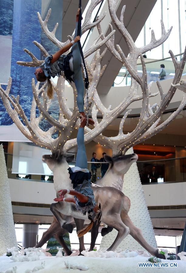 Australian performers perform stunt skills at the International Finance Center Mall in Hong Kong, south China, Dec. 13, 2012. A group of Autralian actors and actresses were invited to present 30 shows which combined stunts and dances in the mall from Thursday until Dec. 26, 2012. (Xinhua/Li Peng)