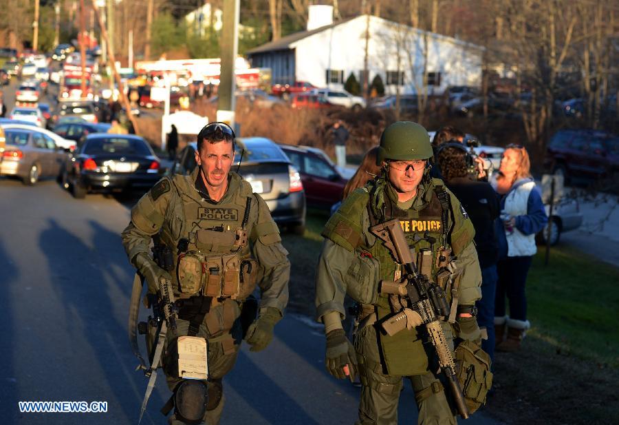 State Police inspect around the Sandy Hook Elementary School after the fatal school shooting in Newtown, Connecticut, the United States, Dec. 14, 2012. Police in U.S. state Connecticut said Friday that 18 children died on the scene at the school shooting here in Sandy Hook Elementary School, two more died later in the hospital. All together 8 adults were also dead. (Xinhua/Wang Lei) 