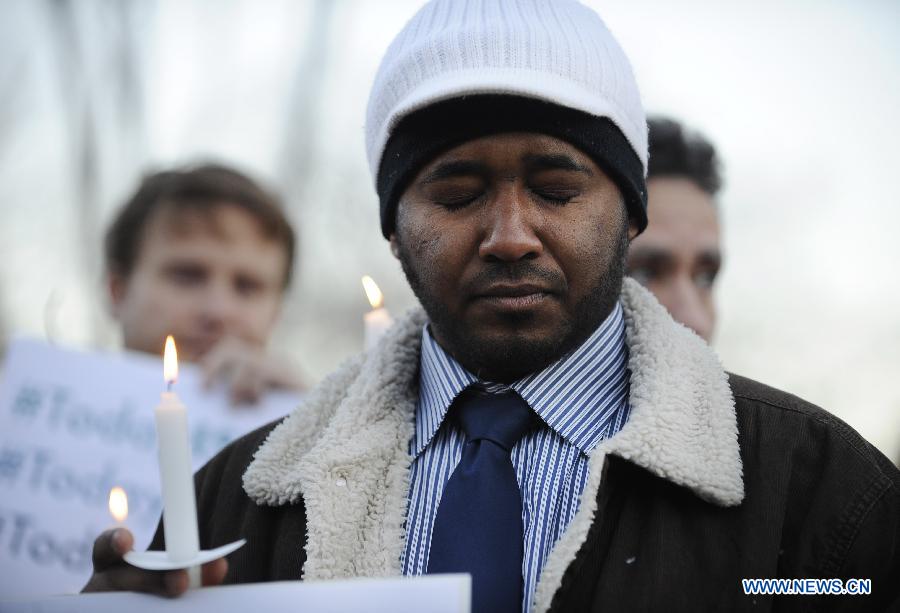 Supporters of gun control legislation hold candles and placards during a rally to pay respect for the shooting victims in front of the White House in Washington, capital of the United States, Dec. 14, 2012, following a deadly shooting spree in an elementary school in Newtown, Connecticut, which took place earlier in the day. (Xinhua/Zhang Jun) 