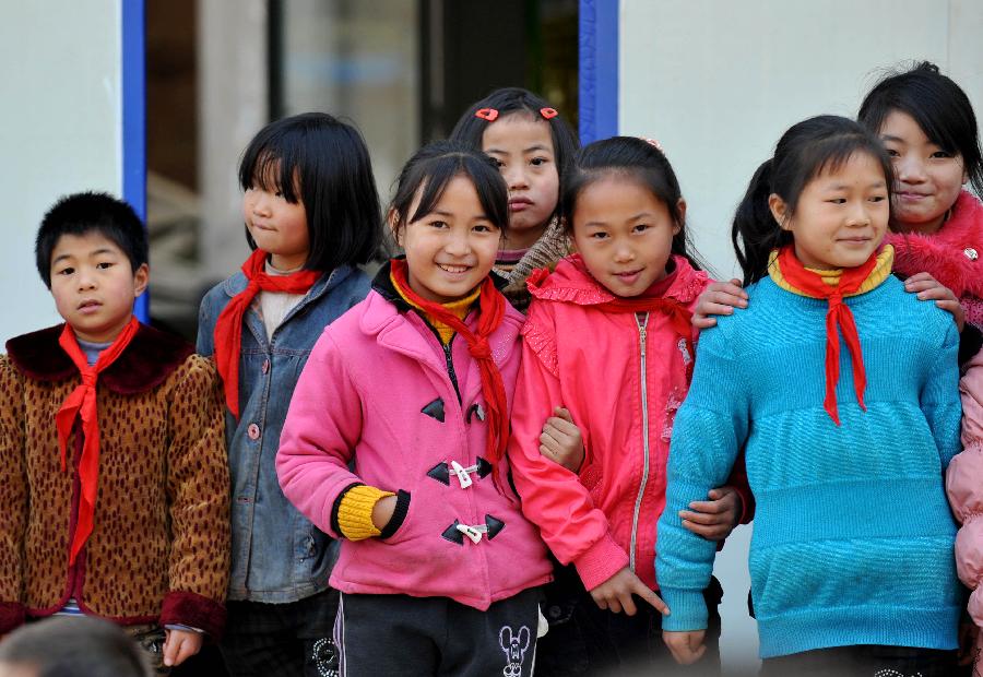 Students take a break at makeshift campus of Maoping Central Elementary School in Luozehe Township of the earthquake-hit Yiliang County, Yunnan Province, Dec. 14, 2012. A total of 1,108 students of the school have all resumed study thanks to the building of the makeshift classrooms. A magnitude 5.7 earthquake in Sept. damaged 294 schools in the county and affected 94,861 students. (Xinhua/Lin Yiguang) 