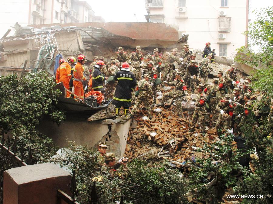 Rescuers search for residents trapped in a collapsed residential building in Ningbo, east China's Zhejiang Province, Dec. 16, 2012. The Five-story residential building collapsed around Sunday noon. The number of casualties is unknown. (Xinhua)