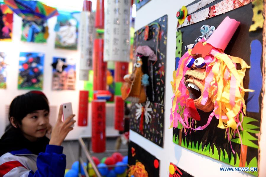 Students view handicrafts made of wastes and scraps during an exhibition in Lanzhou, capital of northwest China's Gansu province, Dec. 14, 2012. A ten-day show themed on environmental protection opened here on Friday, during which over 1,800 artworks made by local primary and middle school students are displayed. (Xinhua/Zhang Meng) 