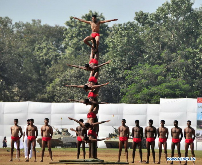 Indian soldiers perform during a military drill and arms exhibition at Shivaji park in Mumbai, India, on Dec. 15, 2012. A troop of Indian Defense Ministry held the military drill and arms exhibition here to raise the public awareness of Indian army and military affairs on Saturday. (Xinhua/Wang Ping)