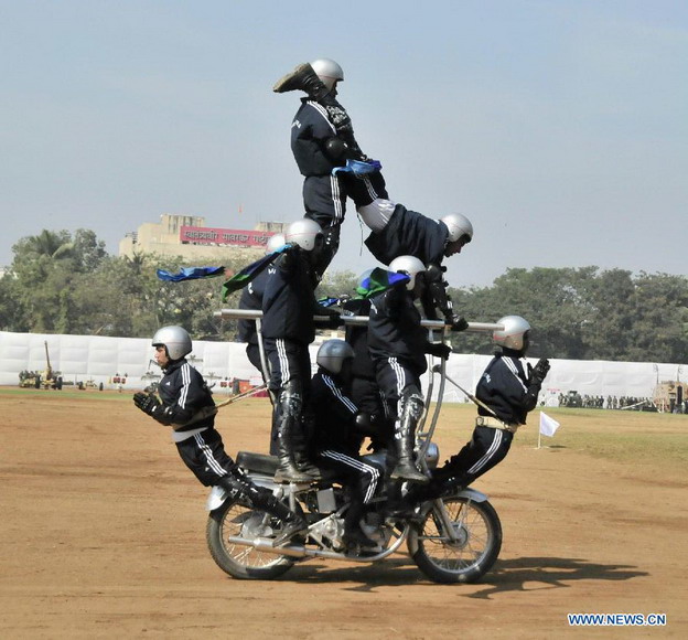 Indian soldiers perform motorcycle stunt during a military drill and arms exhibition at Shivaji park in Mumbai, India, on Dec. 15, 2012. A troop of Indian Defense Ministry held the military drill and arms exhibition here to raise the public awareness of Indian army and military affairs on Saturday. (Xinhua/Wang Ping) 