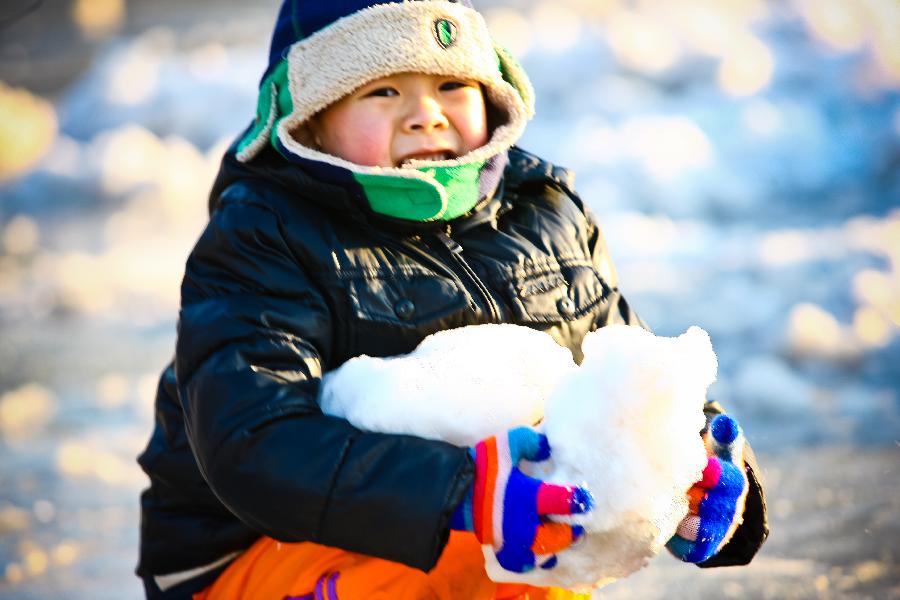 A kid enjoys himself upon the ice in Taoranting Park in Beijing, capital of China, Dec. 17, 2012. (Xinhua/Zhang Cheng) 