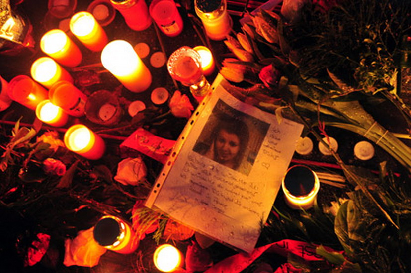 The picture of a school shooting victim is seen in the middle of a sea of flowers and candles left by residents in Winnenden, Germany. A teenager gunned down 15 people in a Germany school on March 11, 2009. (Xinhua/AFP Photo)