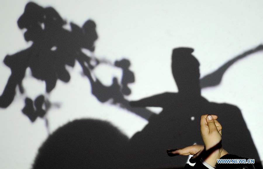 A student performs hand shadow at Ziyan Primary School in Mianzhu, a city in southwest China's Sichuan Province, Dec. 14, 2012. Shen has been teaching students at the primary school every week since last September. (Xinhua/Xue Yubin) 