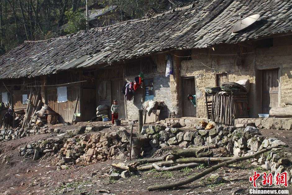 Children look at strangers with curiosity. The family of the two kids on picture has only one mud hut. (Chinanews/Feng Zhonghao)