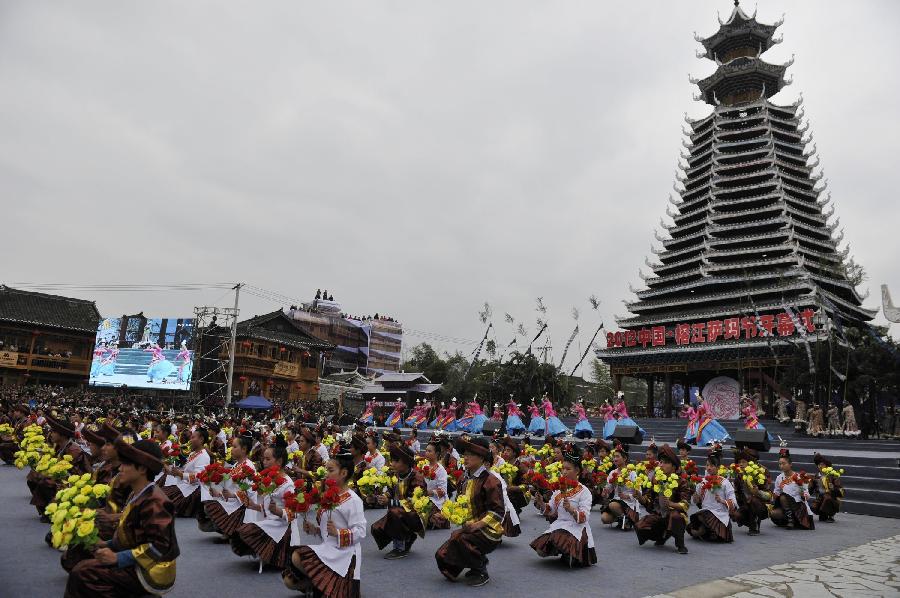 People from Dong ethnic group dance in the opening ceremony of the Sama Festival in Rongjiang County, southwest China's Guizhou Province, Dec. 18, 2012. The Sama Festival, an ancient traditional festival commemorating the woman ancestors of Dong ethnic group, was listed as one of China's state intangible cultural heritages in 2006. The festival of this year will last till Dec. 20. (Xinhua/Ou Dongqu) 