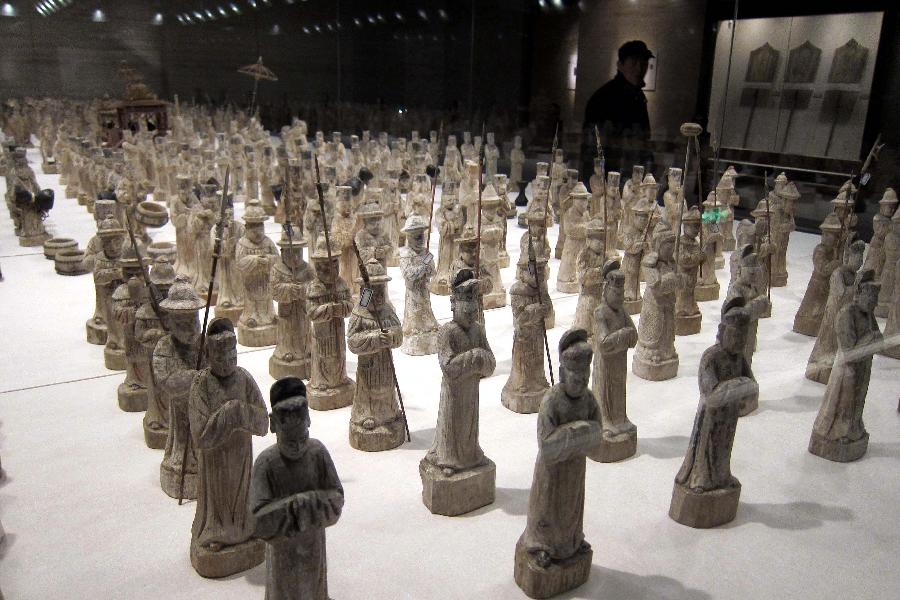 A visitor views puppets depicting a guard of honor in the Ming Dynasty (1368-1644) at the Shandong Museum in Jinan, capital of east China's Shandong Province, Dec. 18, 2012. The Shandong Museum has been listed among the second batch of China's national first-level museums, according to the State Administration of Cultural Heritage. (Xinhua/Xu Suhui) 