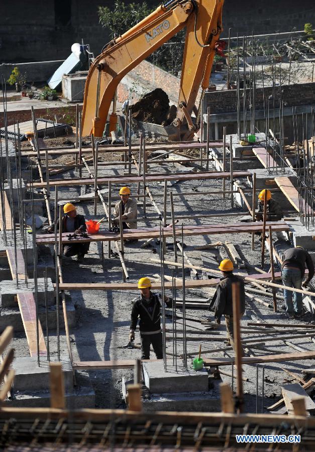 Workers are busy with reconstruction in Maoping Village of Luozehe Township in the earthquake-hit Yiliang County, southwest China's Yunnan Province, Dec. 13, 2012. (Xinhua/Lin Yiguang)