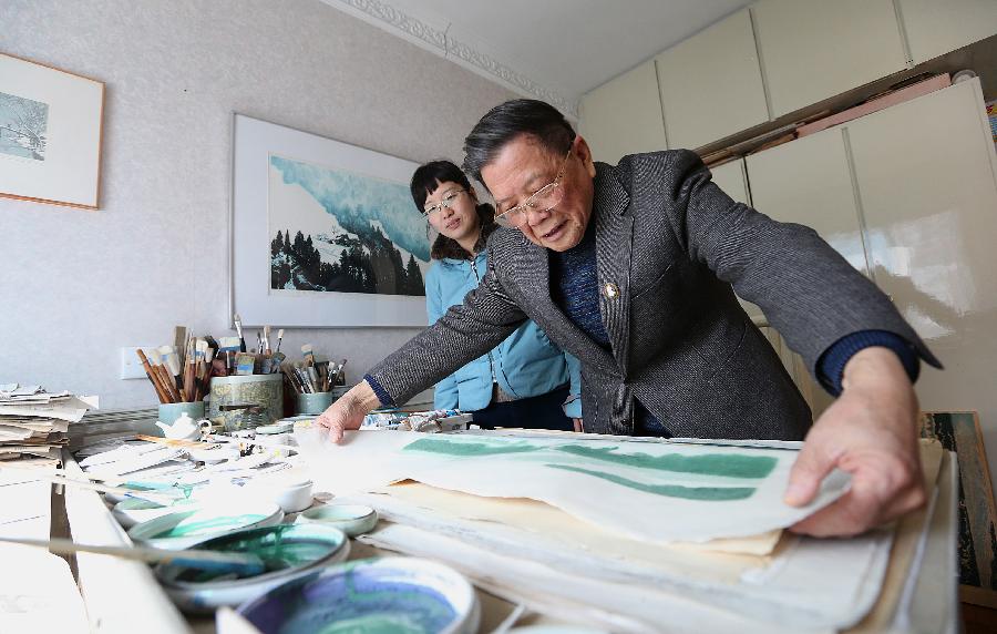 Chinese painter Lu Fang (R) creates a woodblock painting at his studio in Hangzhou City, capital of east China's Zhejiang Province, Dec. 4, 2012. Lu Fang started to create woodblock paintings since 1950s, his works tend to depict the scenery of the West Lake in Hangzhou. The technique of woodblock printing was listed as a state intangbile cultural heritage of China in 2008. (Xinhua/Zhang Chuanqi) 