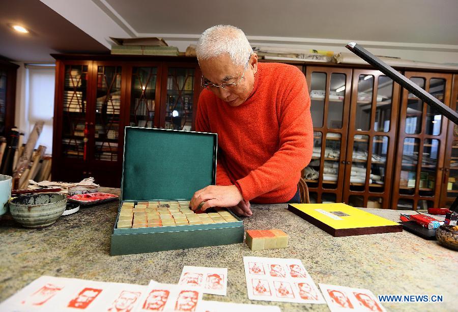 Zhang Gengyuan, a portrait seal cutting master, displays his portrait seals in his studio in Hangzhou, capital of east China's Zhejiang Province, Dec. 4, 2012.(Xinhua/Zhang Chuanqi)  