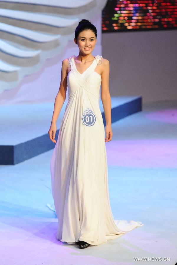 A contestant is pictured on a evening wear show during a beauty contest in Changchun City, capital of northeast China's Jilin Province, Dec. 19, 2012. (Xinhua/Xu Chang)  