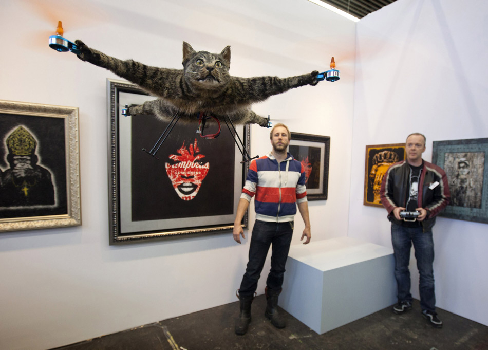 Bart Jansen, a Dutch artist, looks at the small helicopter model made of his cat “Orville”. Orville is killed in a traffic accident. Bart named the model after the cat. He thought, “Orville” could continue to do what it used to like to do - chase the birds in the sky.(Xinhua/Reuters)