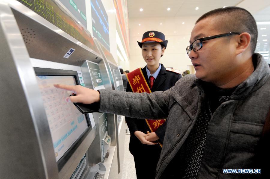 A man buys ticket on a ticket vending machine at the Zhengzhou East Railway Station in Zhengzhou, capital of central China's Henan Province, Dec. 20, 2012.