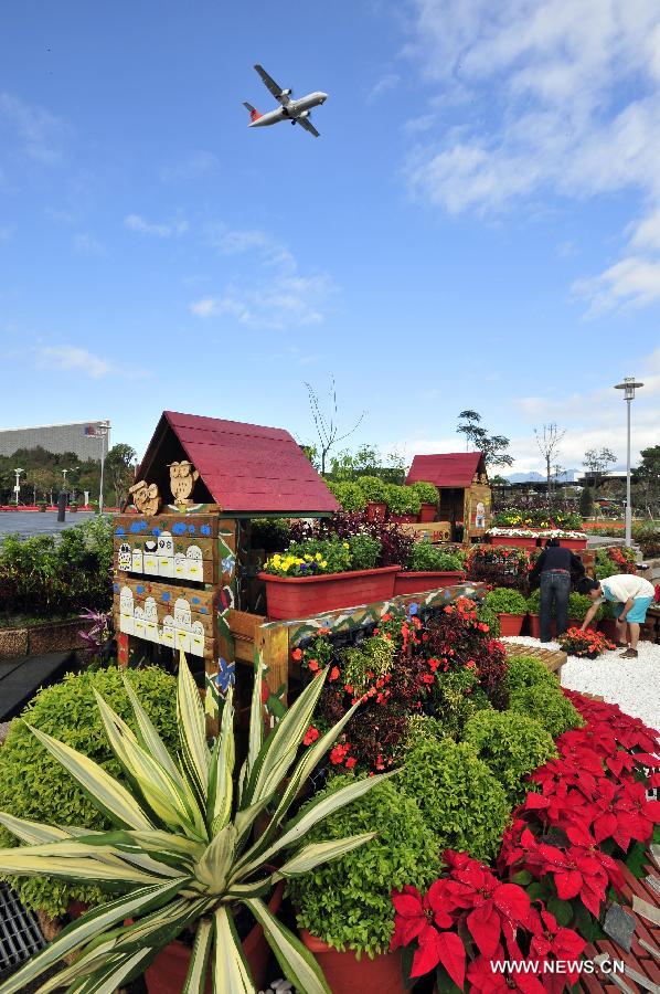 A plane flies over the site of Taipei International Flower Exhibition 2012 in Taipei, southeast China's Taiwan, Dec. 20, 2012. The flower exhibition will formally kick off in Tapei on Dec. 22. (Xinhua/Wu Ching-teng) 